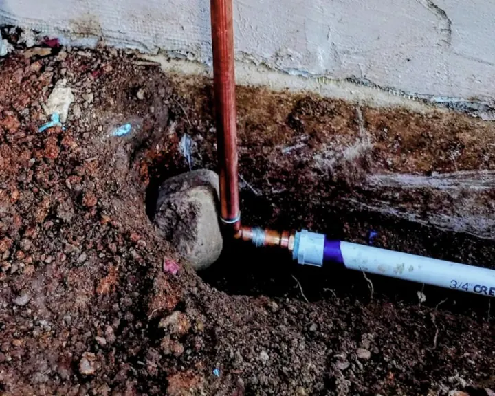 A 90 degree irrigation pipe connection in the ground for irrigation maintenance and seasonal tune-ups